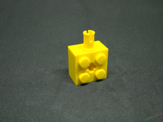 Lego kostička náprava pro kolo s otvorem pro křížovou tyč žlutá 2x2 - velký pin