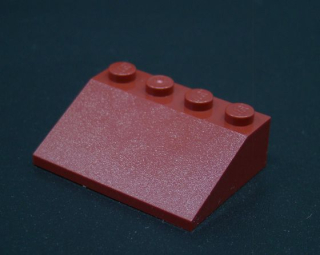 Lego šikmá kostka 33 3x4 tmavě červená